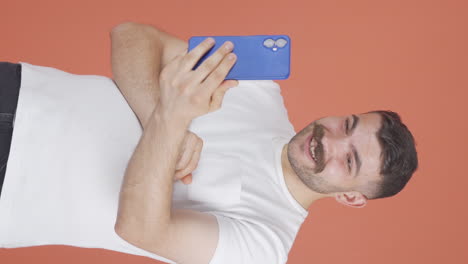 Vertical-video-of-Man-making-a-video-call-on-the-phone.